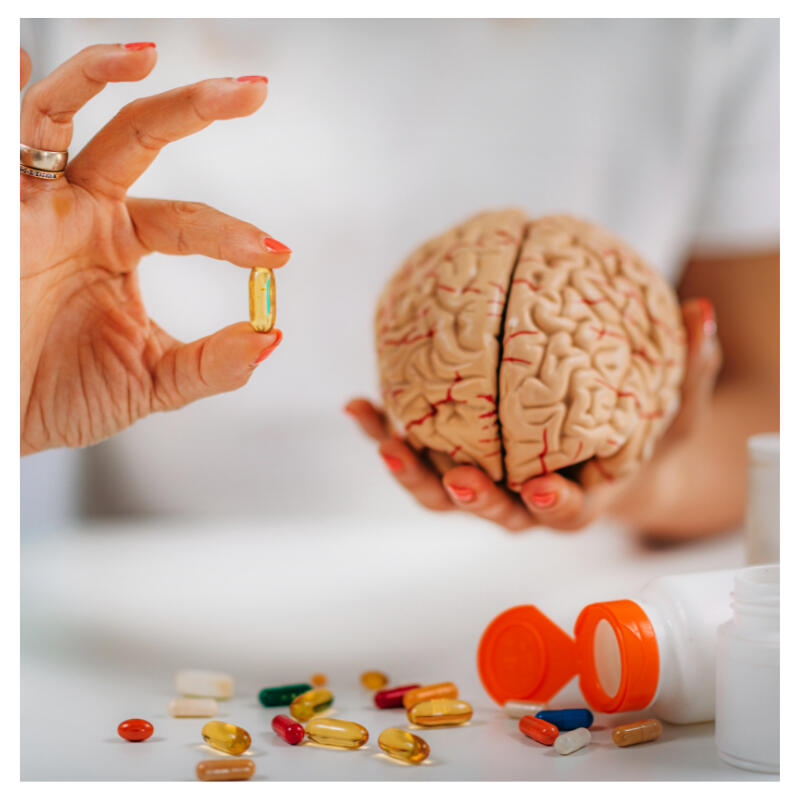 A human brain in hand with supplements around it - Best Brain Supplement for Focus and Mental Clarity